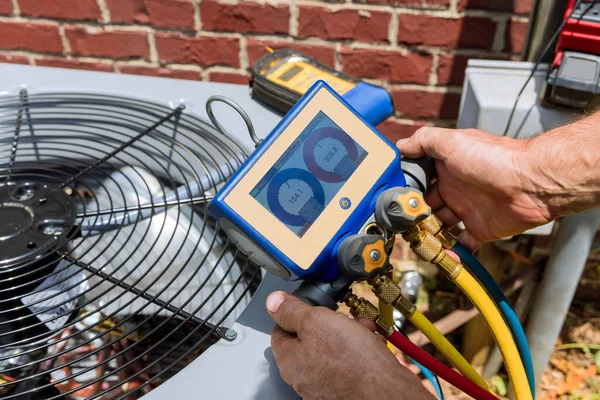 A person is working on an air conditioner.