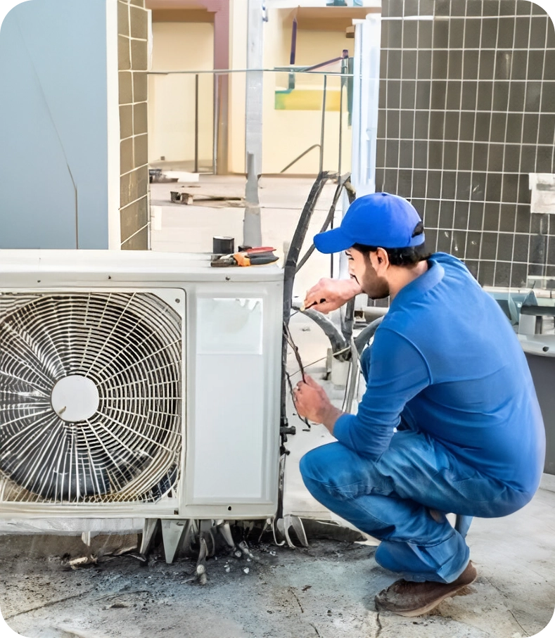 A man working on an air conditioner unit.